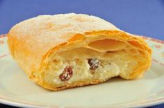 a cranberry filled pastry sitting on top of a white plate