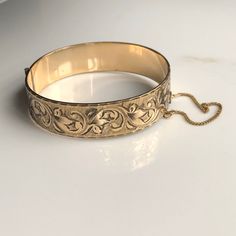 A vintage 9 carat rolled gold bangle. What a beautiful piece, with elegant leaf detailing and such a shine! CONDITION: Good condition, wear consistent with age and use. Please see photos for more detail. MARKED 9 CARAT ROLLED GOLD  INTERNAL SIZE: 180mm BANGLE WIDTH: 19mm BANGLE INTERNAL DIAMETER: 59mm / 53mm WEIGHT: 29.0 grams Antique Yellow Gold Bangle For Formal Occasions, Antique Gold Bracelet Stamped 14k, Antique 14k Stamped Gold Bracelet, Antique 14k Stamped Bangle As Gift, Victorian Gold Bangle Bracelet For Formal Events, Victorian Gold Bracelet For Formal Occasions, Classic Gold Bracelet With Intricate Design, Classic Gold Bangle With Intricate Design, Classic Gold Bangle Bracelet With Intricate Design