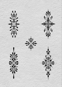 six black and white designs on paper with watermarks in the shape of snowflakes