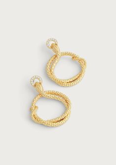 Elevate your style with the luxurious Serpent Holding Ring Hoop Earrings. Crafted from 18K gold dipped brass and adorned with sparkling handset pavé crystals, these earrings exude sophistication and opulence. Indulge in elegance with these stunning earrings. Made from 18K gold dipped brass and encrusted with dazzling handset pavé crystals, these hoops exude luxury and glamour. 18K gold plated brass Crystals 2" L X 1.4" W Gold Diamond Hoop Earrings For Evening, Luxury Gold Hoop Earrings With Pave Setting, Gold Cubic Zirconia Hoop Earrings For Evening, Glamorous Gold Plated Yellow Gold Hoop Earrings, Elegant Gold Hoop Earrings With Pave Setting, Gold Pave Setting Earrings For Evening, Evening Gold Earrings With Pave Setting, Luxury Hoop Earrings, Queen Victoria Engagement Ring