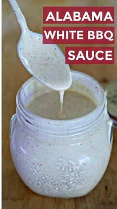 white bbq sauce in a mason jar with a spoon