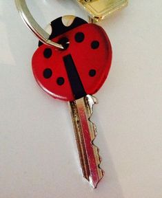 a red ladybug keychain sitting on top of a white table