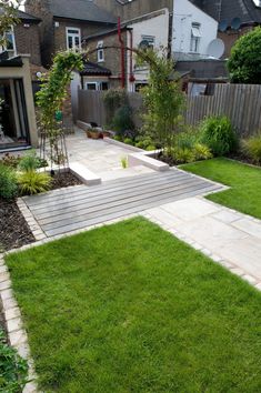 a garden with grass and wooden steps