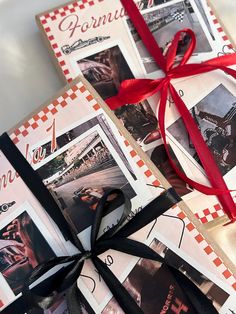 two wrapped gift boxes with red ribbon tied around the edges and pictures on them, both decorated in black and white