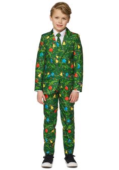 a young boy wearing a green suit and tie with christmas trees all over the pattern