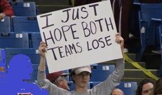 a man holding up a sign that says i just hope both players win in the game