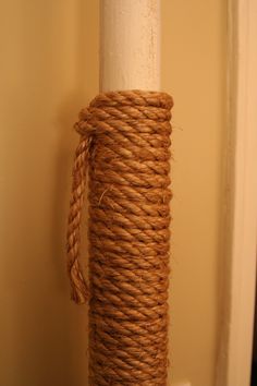 a roll of rope wrapped around a white pole