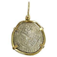 The Vintage Atocha Yellow Gold and Silver Pendant features a unique blend of materials with a vintage coin encased in a 14-karat yellow gold bezel. The wear on the coin adds character and tells a story, while the combination of gold and silver enhances its visual appeal. The pendant measures 28mm x 43mm (including bail). The bezel tests as 14-karat yellow gold and the coin is 925 silver. The total gold weight of the pendant is 10.08 grams. There is no paperwork available for this item. On Septem Byzantine Yellow Gold Necklace With Coin Pendant, Ancient Yellow Gold Coin Pendant Jewelry, Gold Mythological Coin Pendant Jewelry, Luxury Byzantine Coin Necklace, Spanish Galleon, Greek Coin Pendant, Spanish Colonial, Florida Keys, Gold Coins