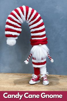 a red and white striped candy cane gnome