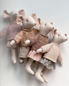 a group of stuffed mice in sweaters and dresses