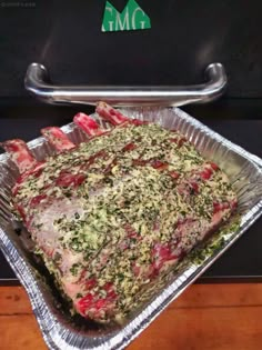 the meat is covered with herbs and ready to be put in the oven for cooking