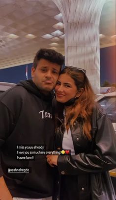 a man and woman standing next to each other in front of a building with the words i miss you already