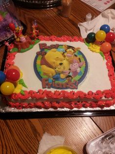 a winnie the pooh birthday cake on a table