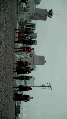 a group of people standing next to each other in front of the empire state building