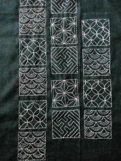 some white stitchs are arranged on a black cloth