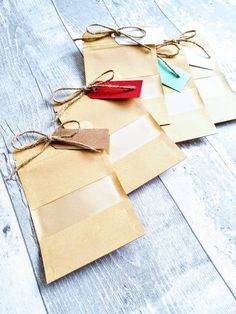 several pieces of brown paper tied with twine on top of white wood flooring