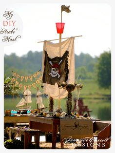 a pirate themed picnic table on the beach with an old flag hanging from it's side