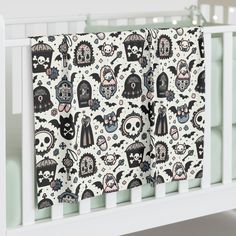 a white crib with two black and white skulls on it