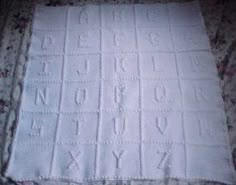 an old blanket that has been made into a tablecloth with letters and numbers on it