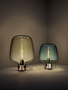 two lamps sitting next to each other on a table