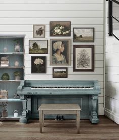 there is a blue piano in the room with many pictures on the wall behind it