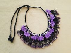 Black and purple crochet bib necklace with amethyst chipbeads. It closes with a knot. Length: adjustable by sliding the knot up or down the cord. Was this not exactly what you were looking for? Have a look at our other necklaces here: http://www.etsy.com/shop/PashaBodrum?section_id=6884137 Don't forget to check out the rest of our shop: http://www.etsy.com/shop/Pasha Note that you pay a lot less in shipping for a second or next item. The combined costs will show up automatically when you put the Black Bohemian Crochet Jewelry, Black Crochet Bohemian Jewelry, Adjustable Crochet Necklaces For Festivals, Adjustable Crochet Necklace For Festivals, Handmade Purple Necklaces For Beach, Handmade Purple Beaded Necklaces For Beach, Handmade Purple Beach Necklaces, Purple Bohemian Crochet Jewelry, Handmade Purple Choker Necklace