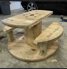 a table made out of pallet wood with two benches on it and the words genius cable spool upcycled into a table and chairs spotted on pinterest