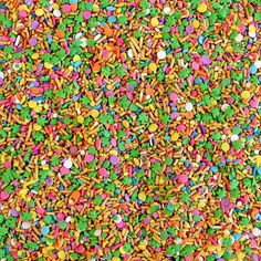 colorful sprinkles and confetti are mixed together in this image,