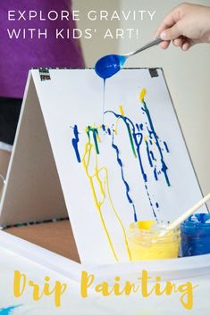 an easel with paint on it and the words, explore gravity with kids art drip painting