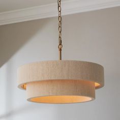 a chandelier hanging from a ceiling in a room with white walls and light fixtures