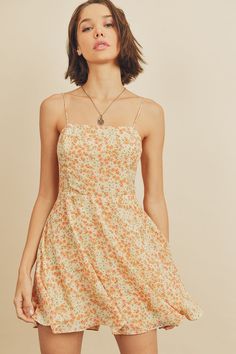 Another fun and flirty sundress to add to your summer wardrobe, our flare fitting Lily Floral cami mini dress is a sweet and soft style that's an absolute must for some outdoor summer fun. Complete with a square neckline, floral design, adjustable straps, smock detail on the back, and an A-line silhouette. Pair perfectly with strappy sandals. Model is 5'9" and wearing size Small. Cami Mini Dress, Button Fashion, Floral Lace Tops, Mini Cami Dress, Floral Cami, Dress Women Elegant, Lemon Cream, Lace Cami Top, White Dresses For Women