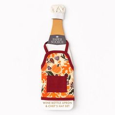 an orange and white flowered wine bottle with red aprons on it's side