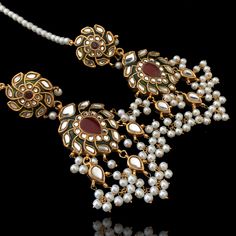 Glamorous and royal - an undoubtedly regal set that will surely add the diva touch to your evening panache! The look includes a necklace and a stunning pair of dangle earrings paired with saharay which is lavishly studded with ruby stones on a green meenakari base and further accented with clusters of faux pearl moti. The necklace comes with an adjustable dori to provide comfort as per your desire. Approximate earrings length is 3.75". Gold-plated on high-quality brass as base metal. Made by ord Elegant Ruby Chandbalis With Meenakari, Elegant Chandbali Ruby Jewelry Sets, Bollywood Ruby Jewelry With Matching Earrings, Elegant Ruby Chandbalis With Intricate Design, Elegant Ruby Danglers For Diwali, Unique Gift Cards, The Diva, Ruby Stone, Faux Stone