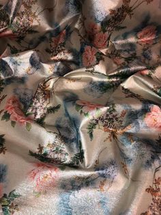 the fabric is covered with flowers and leaves