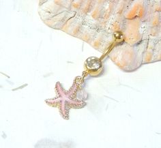 Starfish Belly Ring Show off your beautiful belly! Belly ring features a textured golden starfish charm with sparkly pink enamel accented with a hand wire wrapped pink agate bead. Belly button ring measures 1 3/4 inches long total length. Barbell is 14g gold plated surgical steel with a 10mm wearable bar length. For Belly Button Rings: https://www.etsy.com/shop/AllAboutClass?section_id=18474235&ref=shopsection_leftnav_1 For Industrial Barbells: https://www.etsy.com/shop/AllAboutClass?ref=l2- Pink Starfish Jewelry For Gift, Pink Star Jewelry With Starfish Charm, Pink Star-shaped Jewelry With Starfish Charm, Pink Starfish Charm Jewelry, Pretty Piercings, Pink Starfish, Bellybutton Piercings, Starfish Jewelry, Belly Piercing Jewelry