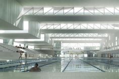 an indoor swimming pool with people in it