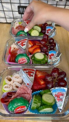 two plastic containers filled with assorted fruit and veggies