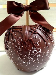 a chocolate covered apple sitting on top of a white table