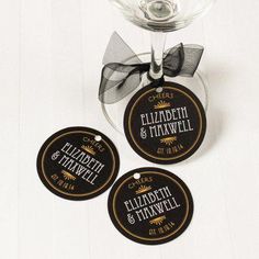 three personalized coasters in front of a wine glass with a bow on it