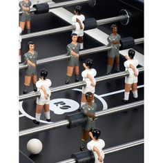 many toy figurines are standing on foosball