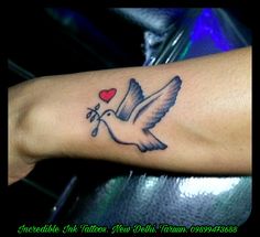 a bird with a heart tattoo on its arm and the word love written in it