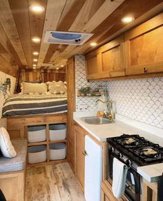 the interior of a small camper with wood paneling and white tile on the walls