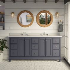 a bathroom with two sinks and mirrors on the wall