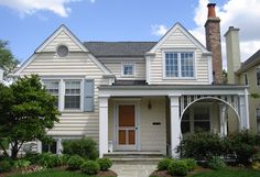 a house with white siding and two story windows