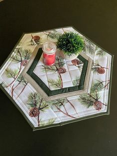 a pine tree placemat with a candle on it