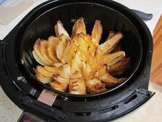 an air fryer filled with fried food on top of a counter