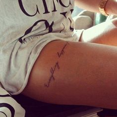 a woman's arm with the word love written in cursive writing on it