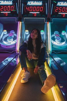 a woman sitting on the edge of a slot machine