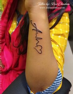 a woman's arm with the word love tattooed on her left wrist, in black ink