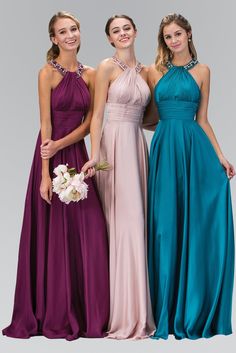 three women in long dresses standing next to each other